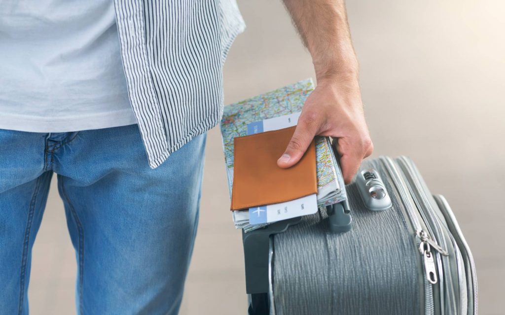man-going-to-flight-with-suitcase-passport