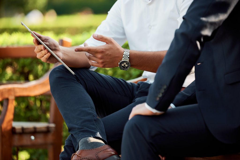 two men looking at a tablet