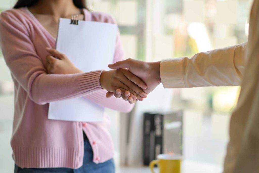 man and women shaking hands