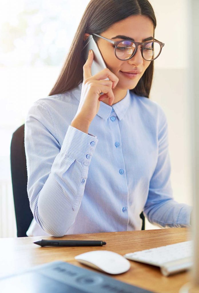 business woman in glasses talking on the phone