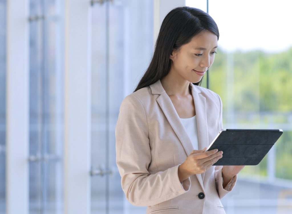 asian business woman looking at tablet