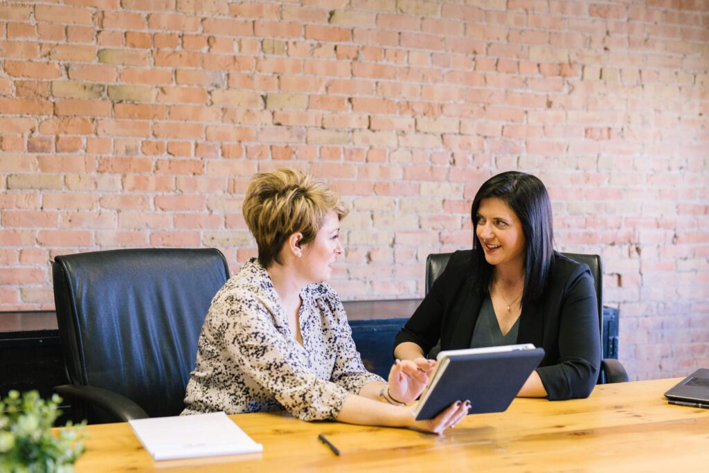 business women talking about benefits of erp