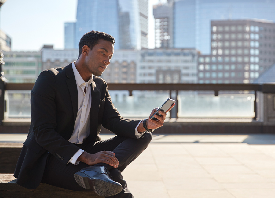 Man checking his smartphone on a landing