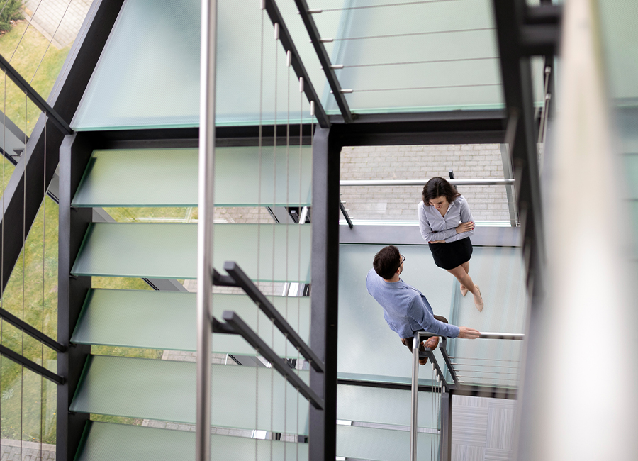 Co-workers having a conversation in a stairwell