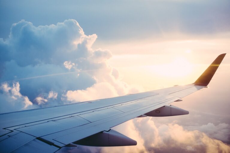 Airplane wing with sunset in the background