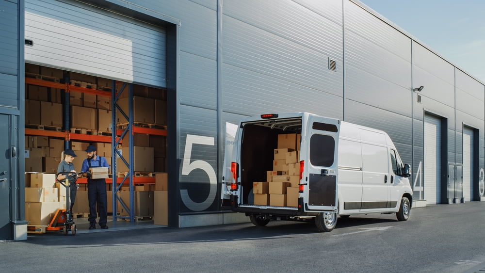 Freight forwarding services warehouse loading shipments into delivery van using a freight forwarding system
